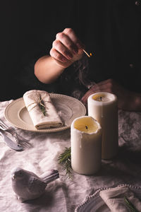 Young woman lights the candles