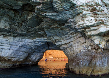 Scenic view of sea seen through cave