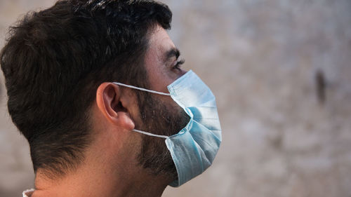 Close-up portrait of young man wearing face mask and copy space 