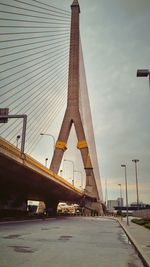 Bridge against cloudy sky