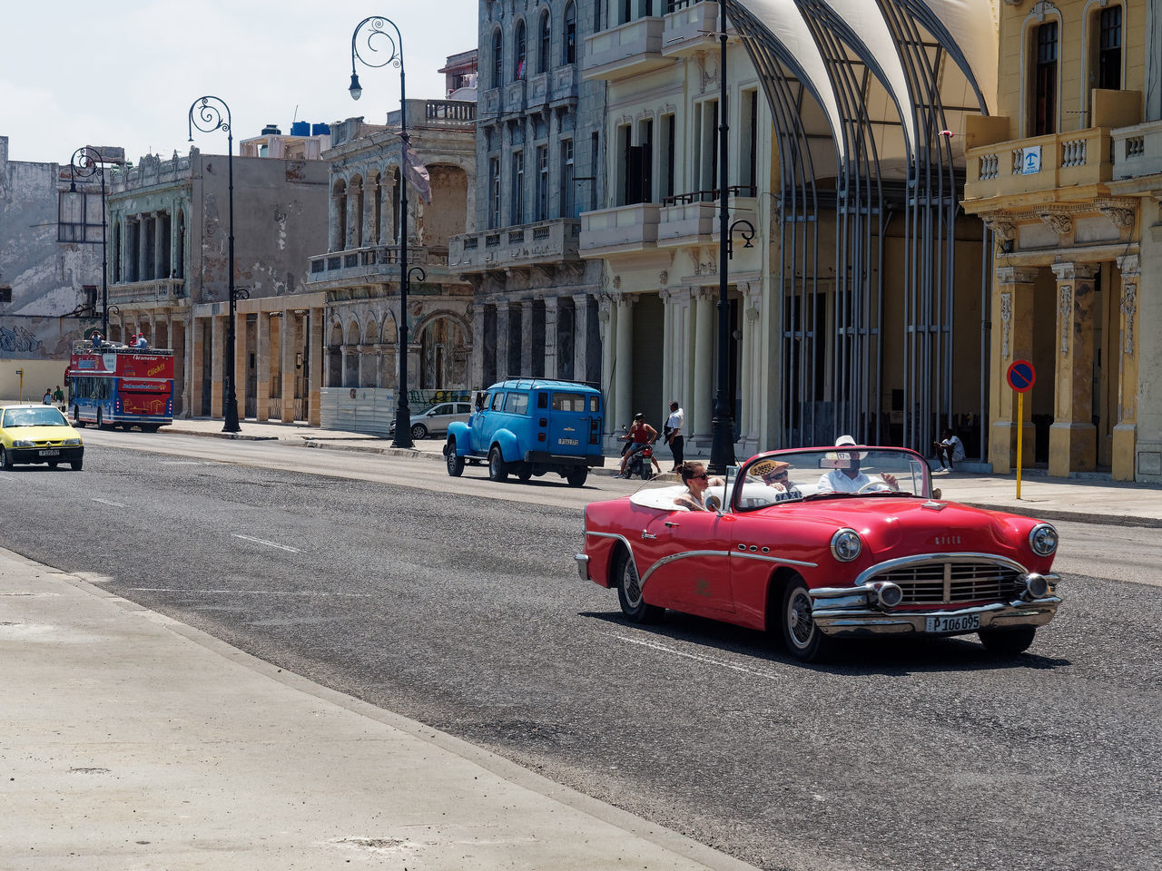 CAR ON STREET AGAINST BUILDINGS IN CITY