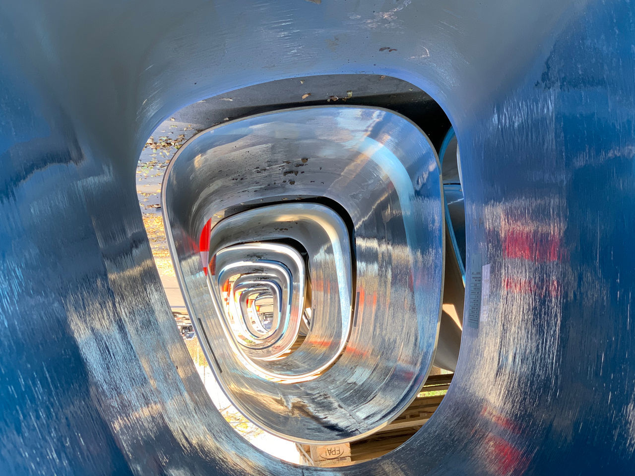 no people, transportation, metal, motion, outdoors, day, water, close-up, mode of transportation, architecture, directly above, reflection, tunnel, shape, nature, high angle view, land vehicle, motor vehicle, wet, silver colored, wheel