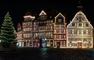 Illuminated building in city at night