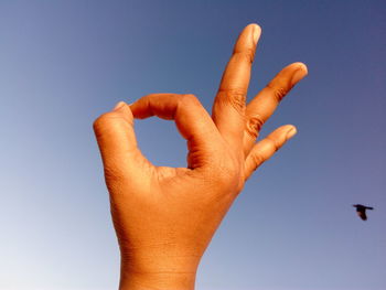 Human hand forming ok sign