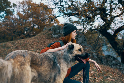 Full length of young woman with dog