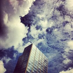 Low angle view of buildings against cloudy sky