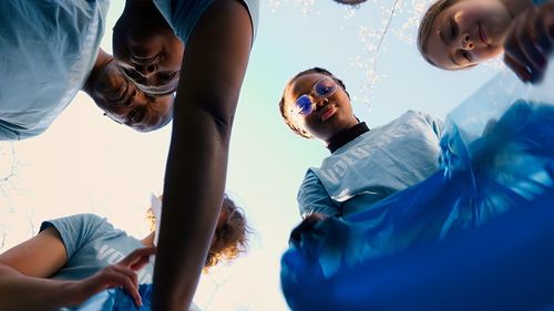 Rear view of woman with arms raised