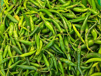 Full frame shot of green chili peppers at market