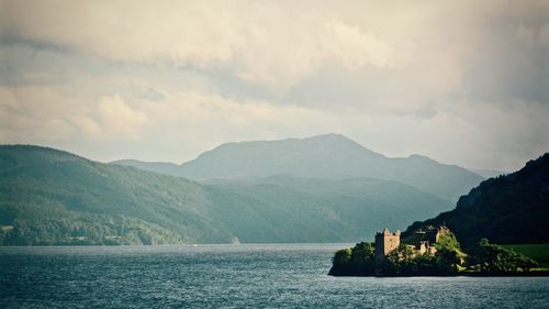 Scenic view of urquhart castle and loch ness with mountains against sky