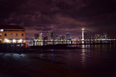 Illuminated city at waterfront