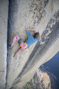 Climbing focused and looking up climbing hard on the nose yosemite