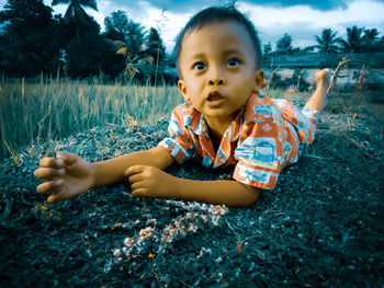 Portrait of cute baby girl on field