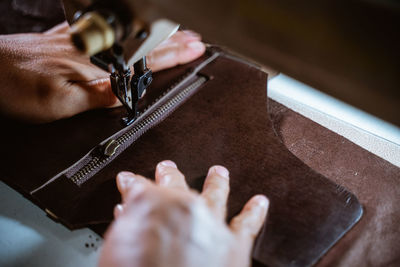 Cropped hand of man working on table