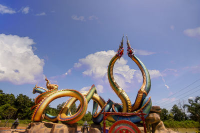  low angle twin stucco painted as a large serpent at pra kai keaw wang nakin, udon thani, thailand. 