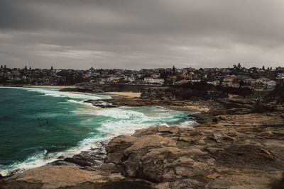 Scenic view of sea and buildings against sky