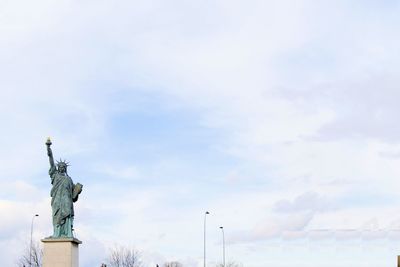 Low angle view of statue against cloudy sky