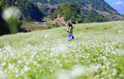 Front view of girl jumping in field