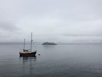 Boats in sea against sky