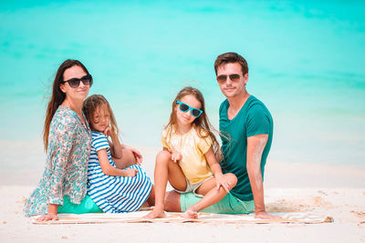 Full length of friends enjoying at beach