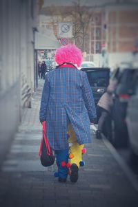 Rear view of person walking on street