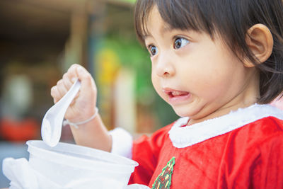 Close-up portrait of cute girl looking away
