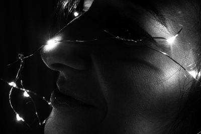 Close-up portrait of young man holding illuminated light