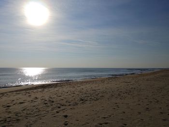 Scenic view of beach against sky during sunset