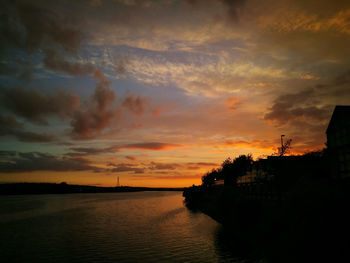 Scenic view of dramatic sky over sea during sunset