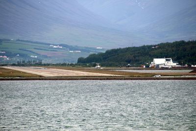 Scenic view of sea and mountains against sky