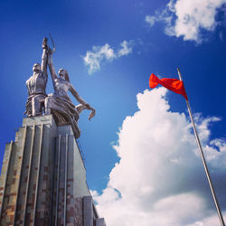 Low angle view of flag against blue sky