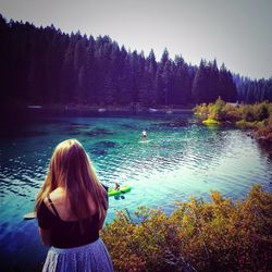 Rear view of woman looking at lake