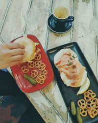 Close-up of hand holding food on table