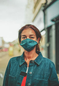 Portrait of young woman standing on street