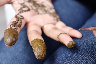 Close-up of hand holding ring