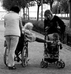 Siblings sitting on street