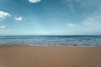 Beautiful sea waves with foam of turquoise color horizon with blue sky and beautiful sand