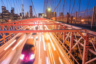 Light trails on bridge in city at night