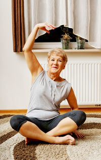 Senior woman exercising at home