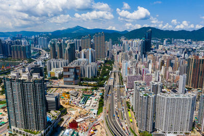 High angle view of modern buildings in city against sky