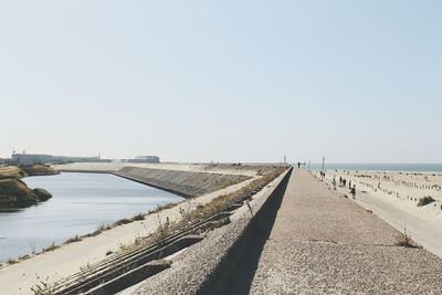 Promenade at beach against clear sky