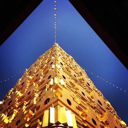 Low angle view of illuminated building against sky