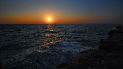 Scenic view of sea against sky during sunset