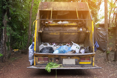 Garbage bin against trees and plants