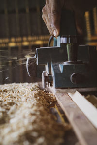 Close-up of person working on metal