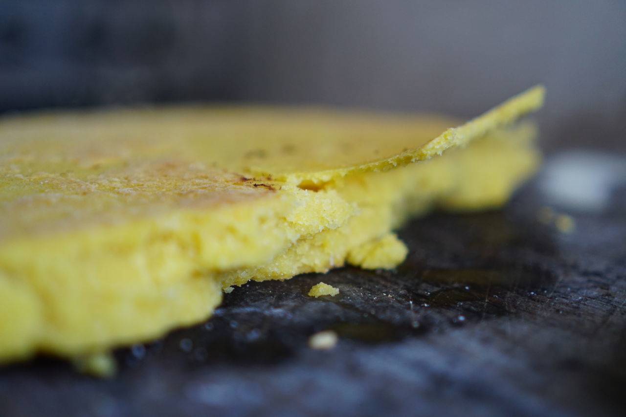 CLOSE-UP OF YELLOW LEAF ON WOODEN TABLE