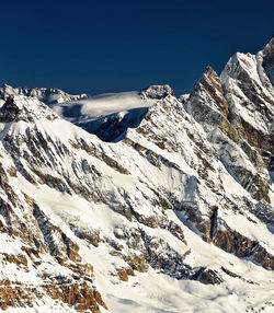 Scenic view of snow covered mountains against sky