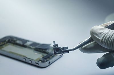 Cropped hand of man repairing circuit board