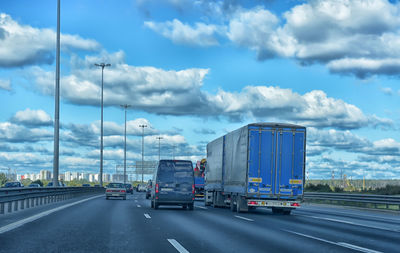 Vehicles on road against sky