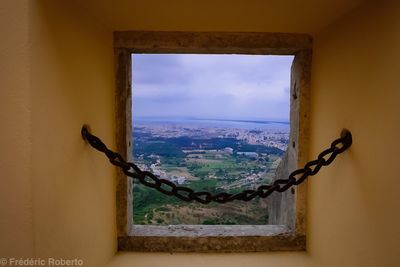 Cityscape against sky seen through window