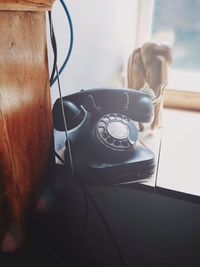 High angle view of telephone on window sill